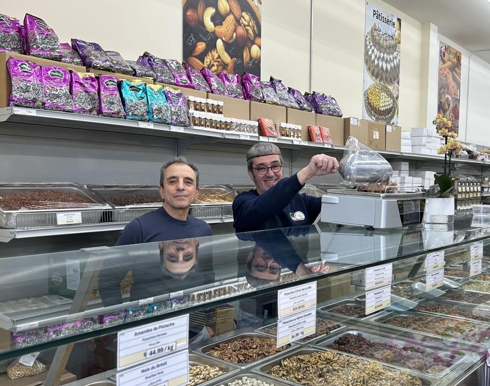 Bardia and Nasser Ajabi at the nut and olive counter at Marché Shahran
